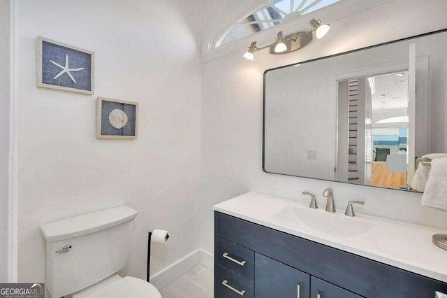 bathroom with vanity, toilet, and plenty of natural light