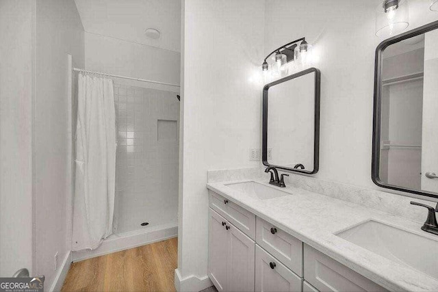 bathroom featuring hardwood / wood-style floors, a shower with curtain, and vanity