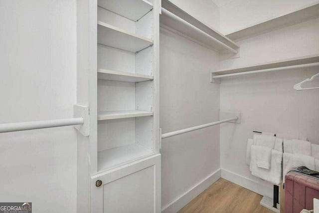 walk in closet featuring light hardwood / wood-style flooring