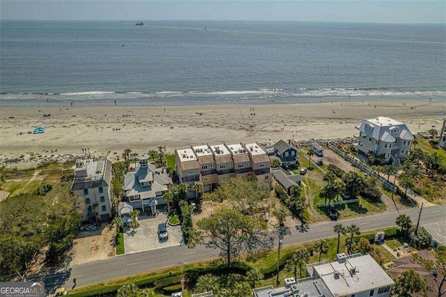 birds eye view of property featuring a view of the beach and a water view