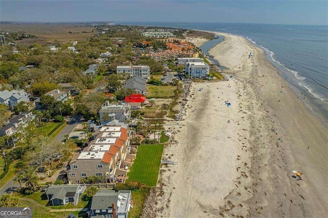 birds eye view of property with a beach view and a water view