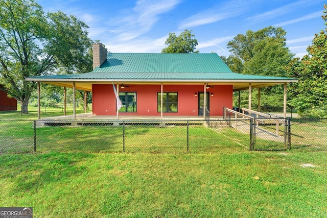 back of property featuring a porch and a yard