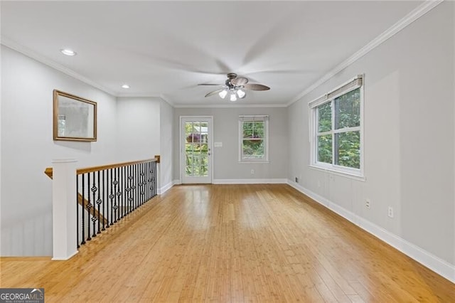 spare room featuring light hardwood / wood-style floors, ceiling fan, and crown molding