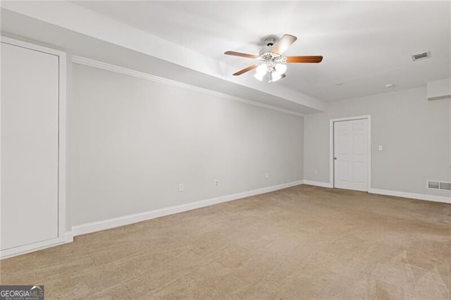 spare room with light carpet and ceiling fan