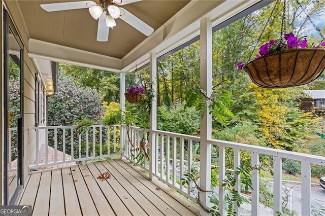 unfurnished sunroom featuring ceiling fan and plenty of natural light