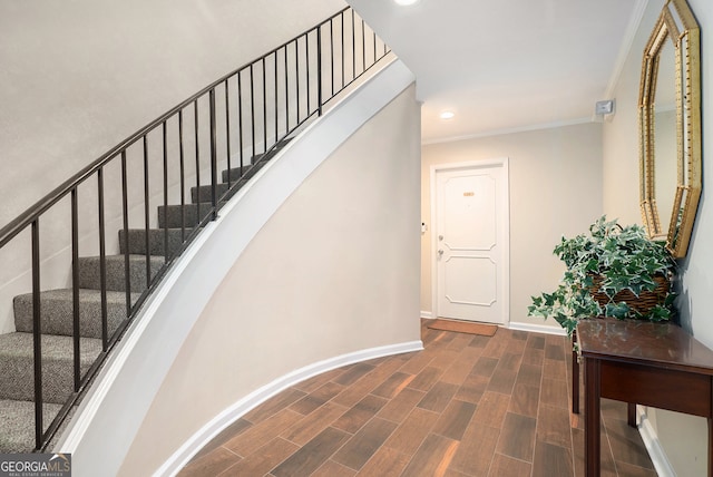 stairs with hardwood / wood-style flooring and ornamental molding