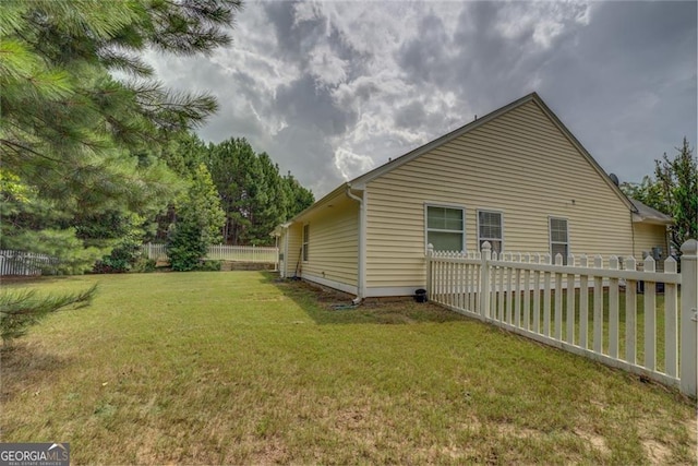 view of side of home featuring a lawn