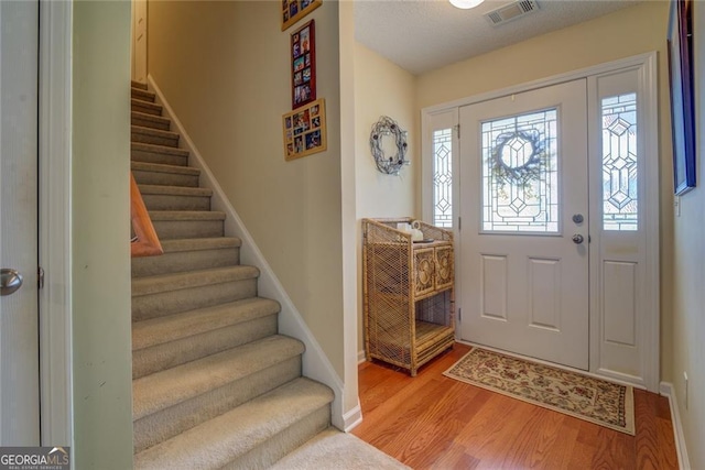 foyer entrance with light hardwood / wood-style flooring