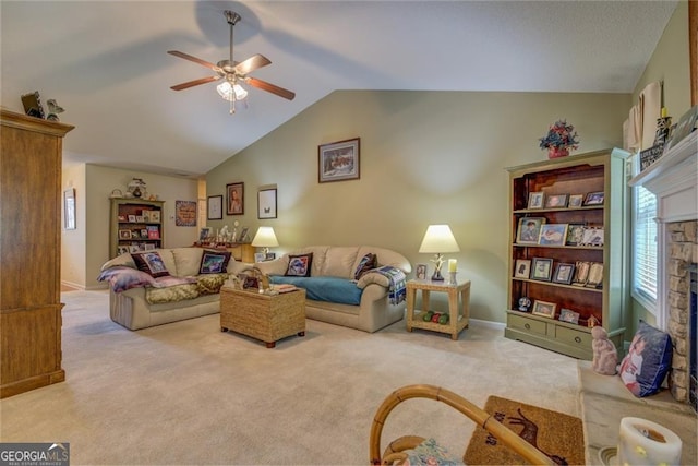 living room featuring a fireplace, vaulted ceiling, ceiling fan, and light carpet