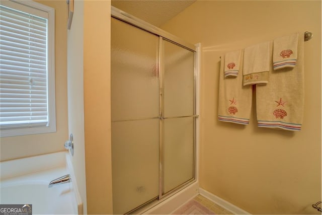 bathroom with a textured ceiling and walk in shower