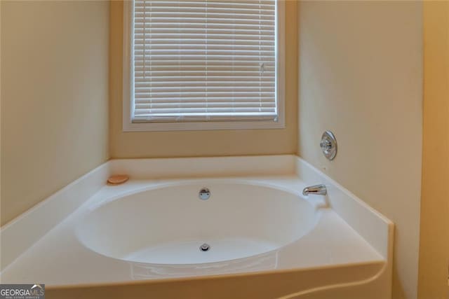 bathroom with a tub to relax in