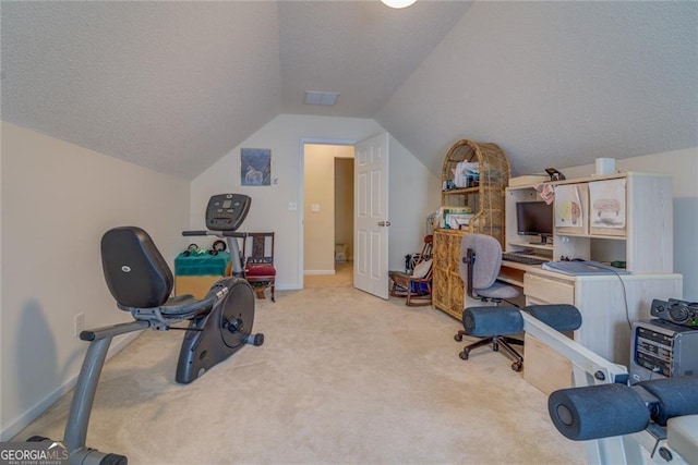 carpeted office featuring lofted ceiling