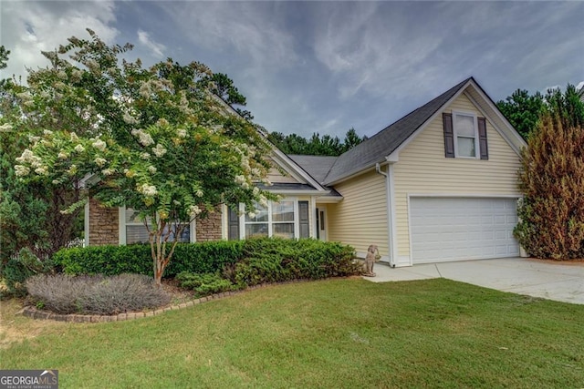 view of front of property with a front yard and a garage