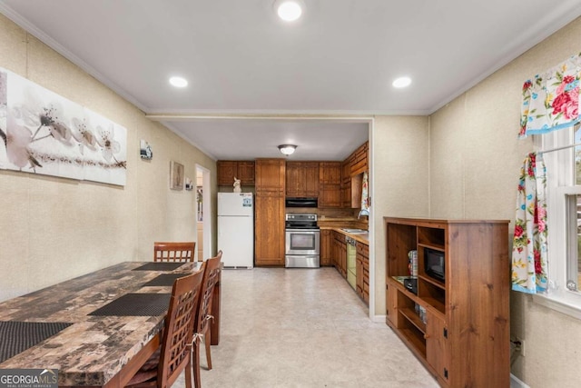 kitchen with black microwave, sink, white refrigerator, stainless steel stove, and ornamental molding