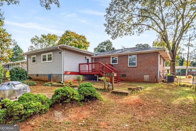 back of house featuring a wooden deck and cooling unit