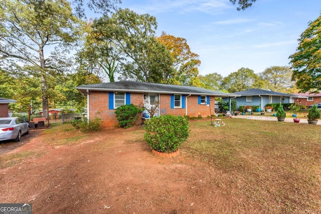 ranch-style house with a front lawn