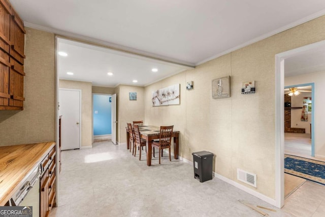 dining room with ceiling fan and ornamental molding