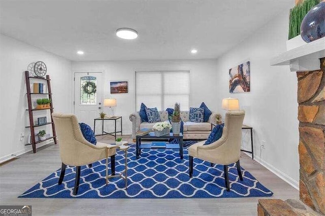 sitting room with a healthy amount of sunlight and light hardwood / wood-style flooring