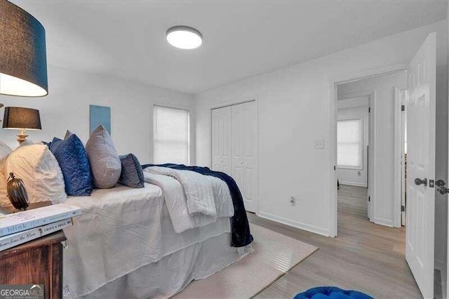 bedroom with light wood-type flooring and a closet