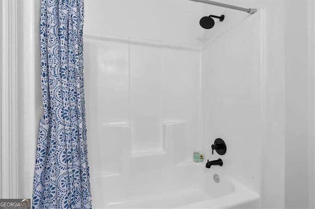 bathroom with shower / bath combination with curtain