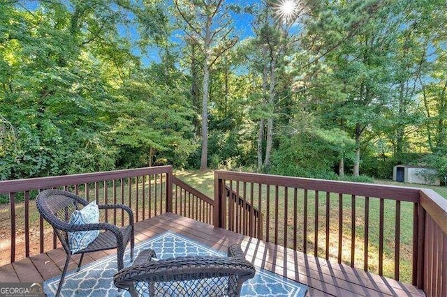 deck featuring a storage unit and a lawn