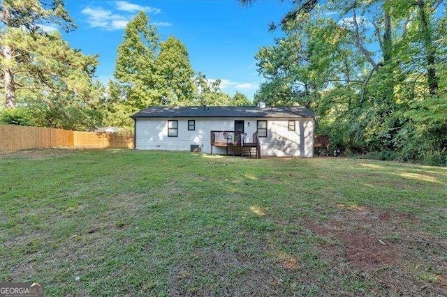 rear view of property featuring a lawn