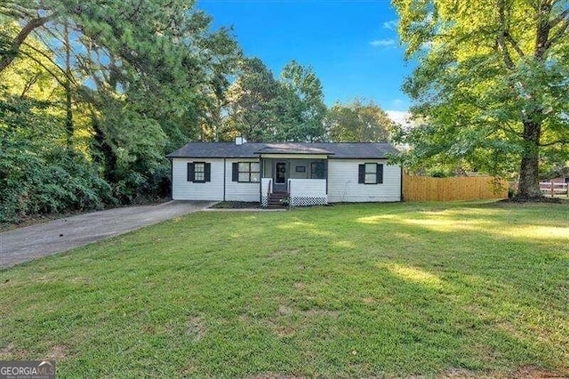 ranch-style home featuring a front yard