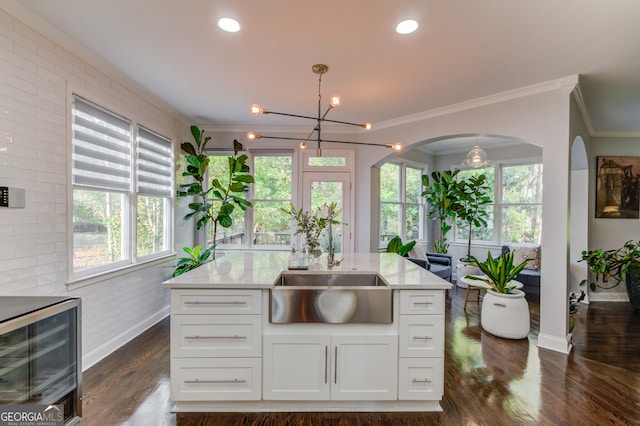 kitchen with pendant lighting, white cabinetry, dark hardwood / wood-style floors, and beverage cooler