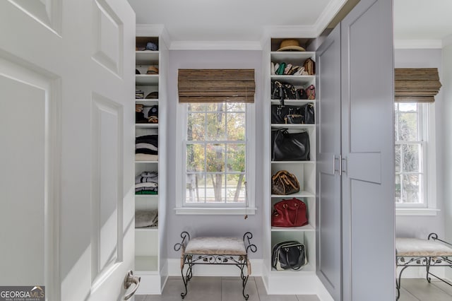 walk in closet with light tile patterned flooring