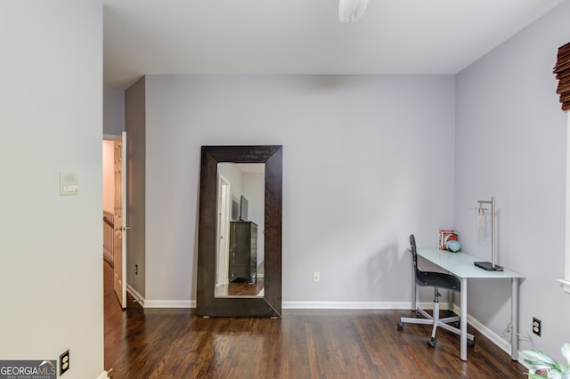 home office with dark hardwood / wood-style flooring