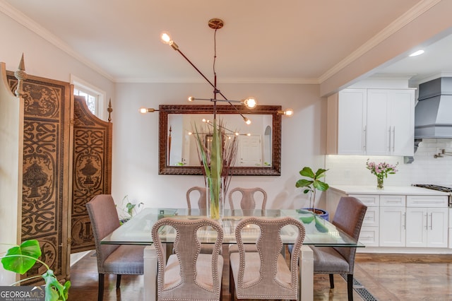 dining space featuring dark hardwood / wood-style flooring and crown molding