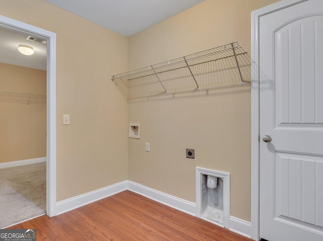 laundry room with hookup for a washing machine, hardwood / wood-style floors, and electric dryer hookup