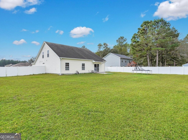 back of house featuring a yard