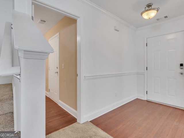 entryway featuring hardwood / wood-style floors and ornamental molding