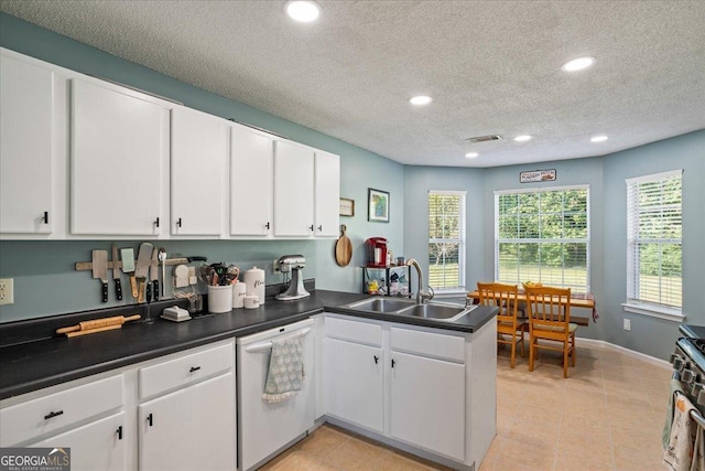 kitchen featuring sink, kitchen peninsula, white dishwasher, a textured ceiling, and white cabinets