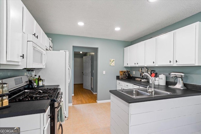 kitchen featuring sink, white cabinets, a textured ceiling, and stainless steel range with gas stovetop