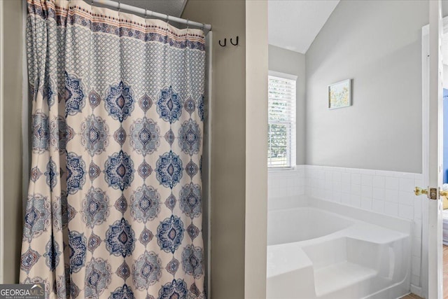 bathroom with separate shower and tub and vaulted ceiling