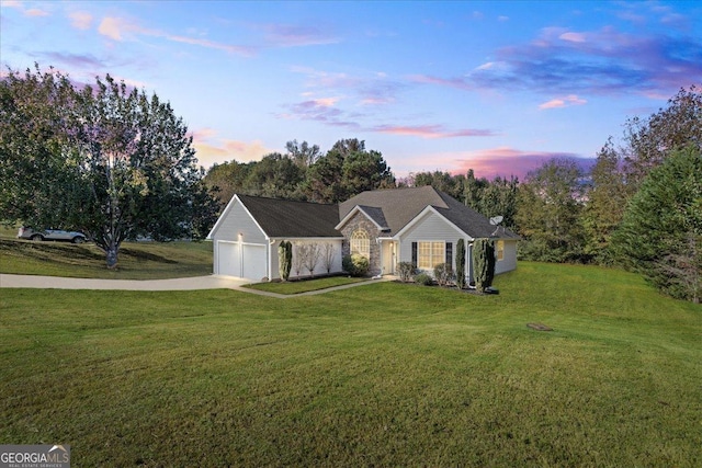 ranch-style home with a lawn and a garage