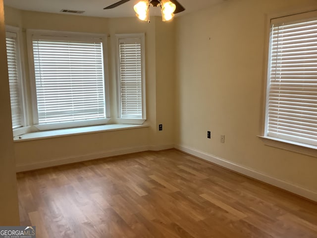 unfurnished room with light hardwood / wood-style flooring and ceiling fan