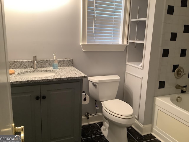 bathroom with tile patterned flooring, vanity, and toilet