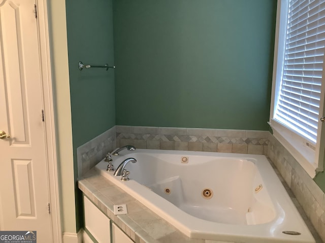 bathroom with a relaxing tiled tub