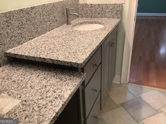 bathroom featuring vanity and backsplash