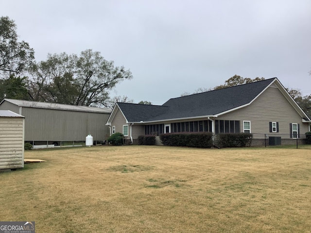 rear view of house featuring a lawn