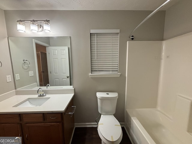 full bathroom featuring  shower combination, vanity, and toilet