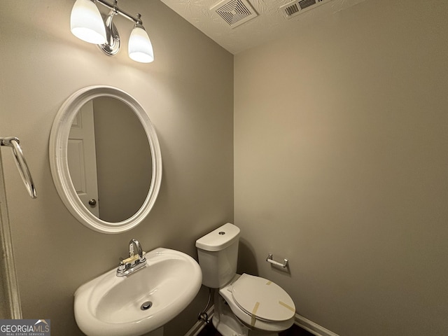 bathroom featuring sink and toilet