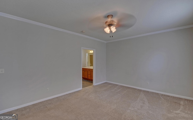 empty room with ceiling fan, light carpet, and crown molding