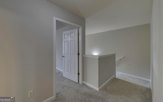 corridor featuring light colored carpet