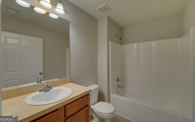 full bathroom featuring vanity, washtub / shower combination, and toilet