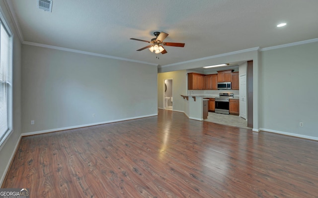 unfurnished living room featuring ornamental molding, a textured ceiling, hardwood / wood-style flooring, and ceiling fan