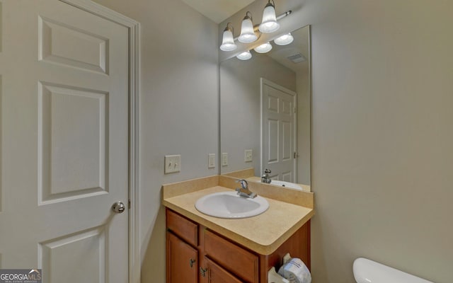 bathroom with vanity and toilet